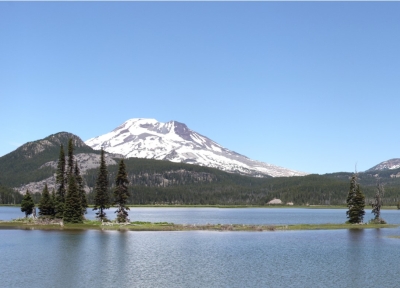 snow capped mountain behind a lake